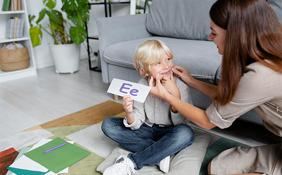 Tutor using a letter card with a young learner